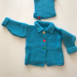 Chunky hand knitted baby jacket with a matching hat