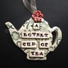Ceramic teapot decoration with button flower