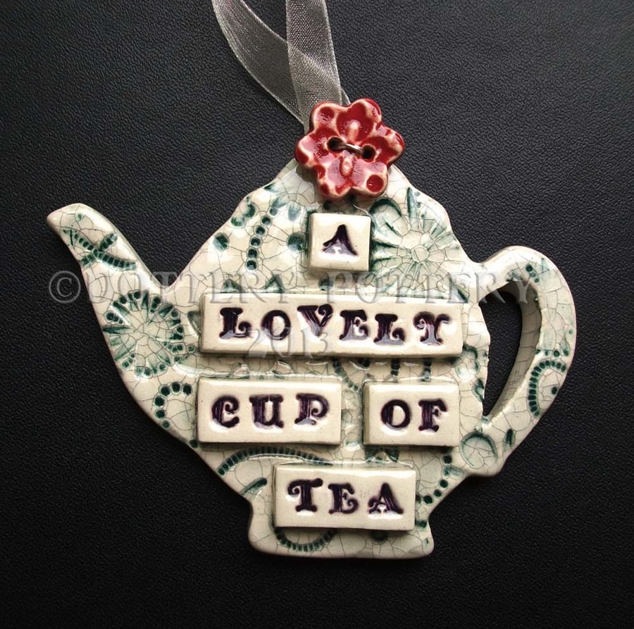 Ceramic teapot decoration with button flower