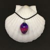 Pink and purple small egg multicoloured pendant and black cord chain.