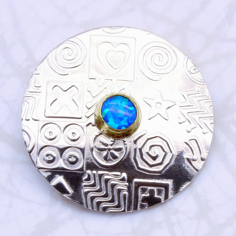 Contemporary round sterling silver brooch featuring a blue Opal, gemstone choice
