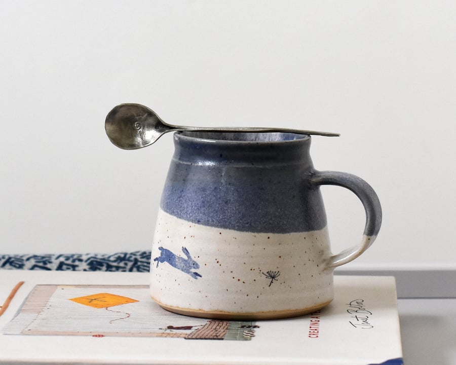 Handmade ceramic mug with blue leaping hare, blue and white pottery