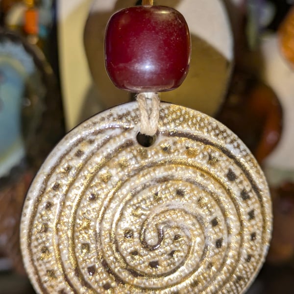 Stoneware necklace: a round ceramic white glaze spiral with Victorian amber bead