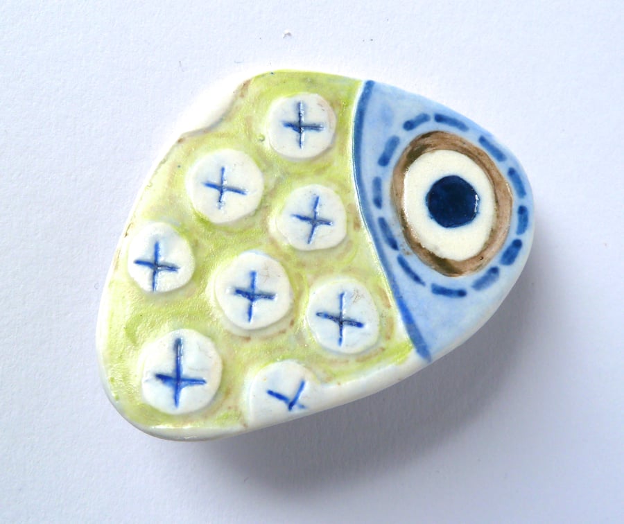 A unique painted porcelain brooch, hand made in Winchester.