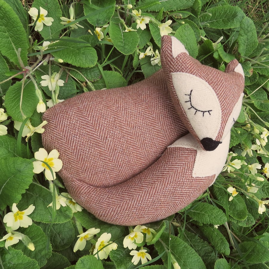 Snoozy fox.  A fox doorstop, made from a tactile herringbone wool.