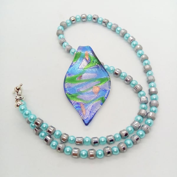 Blue Glass Teardrop Shaped Pendant on a Grey and Blue Beaded Necklace