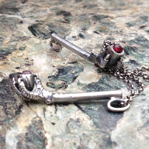 Silver egg and claw pipe charm 