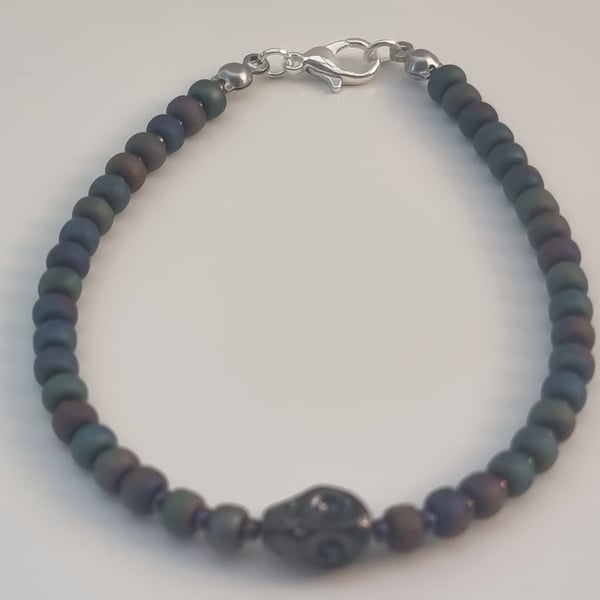 Black metallic seed bead bracelet with black skull