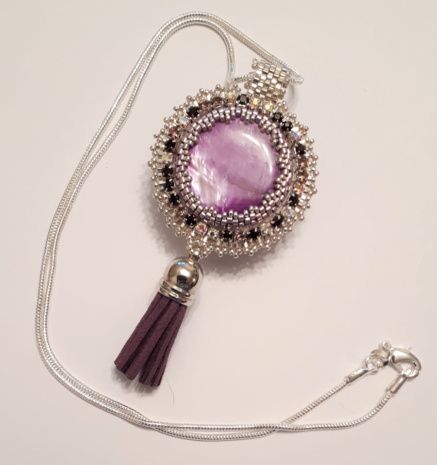 Bead embroidered Purple shell pendant on a silver tone chain   