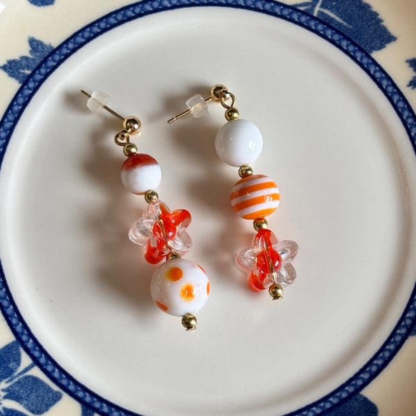 Orange and white asymmetrical earrings 