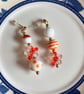 Orange and white asymmetrical earrings 