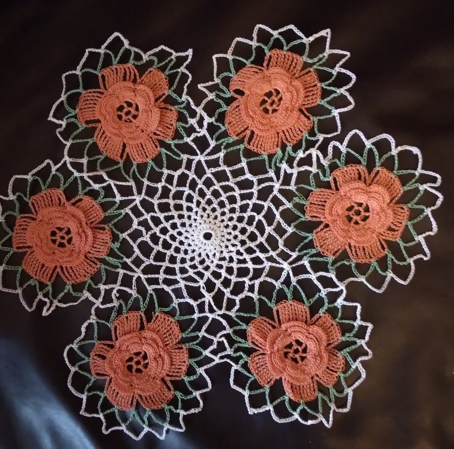 Crochet cotton table mat in white with orange flower border
