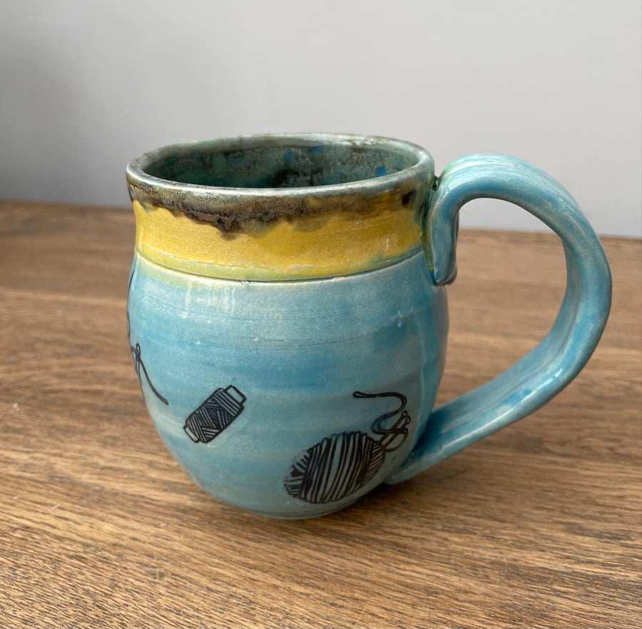 Handmade ceramic mug with needle ,thread, wool design 10oz capacity