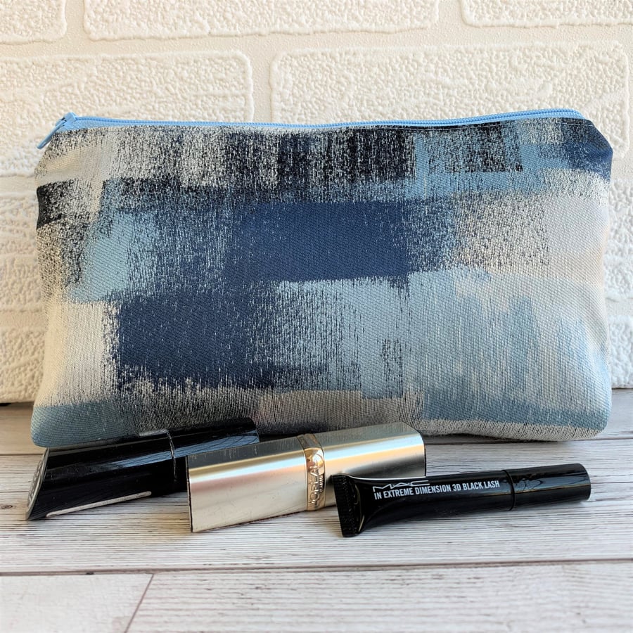 Blue make up bag with abstract squares pattern