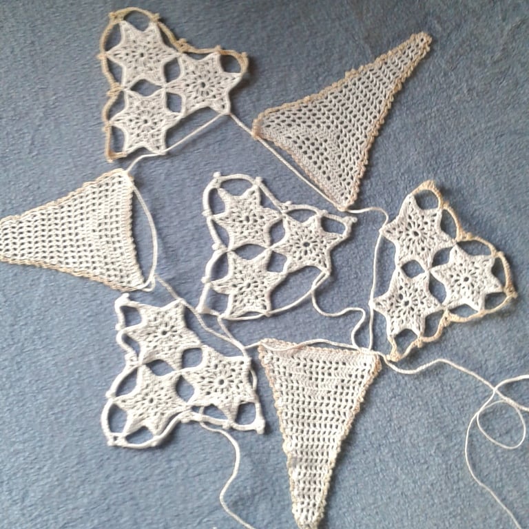 Bunting, hand crocheted lace from a vintage pattern with Filet and stars motifs.