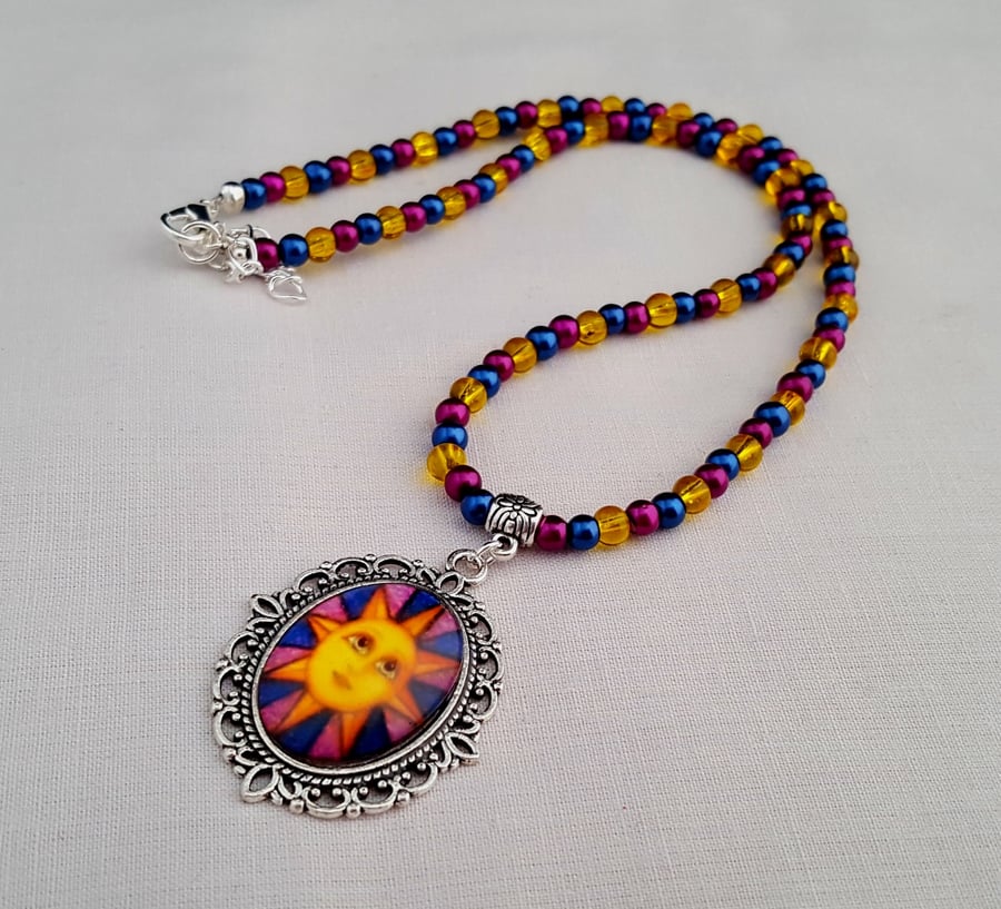 Blue, magenta and yellow sun face pendant necklace - 1001786