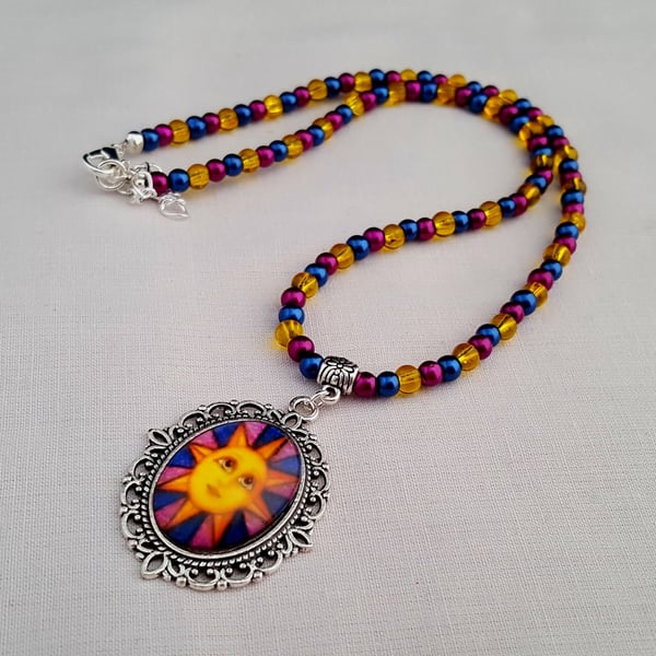 Blue, magenta and yellow sun face pendant necklace - 1001786