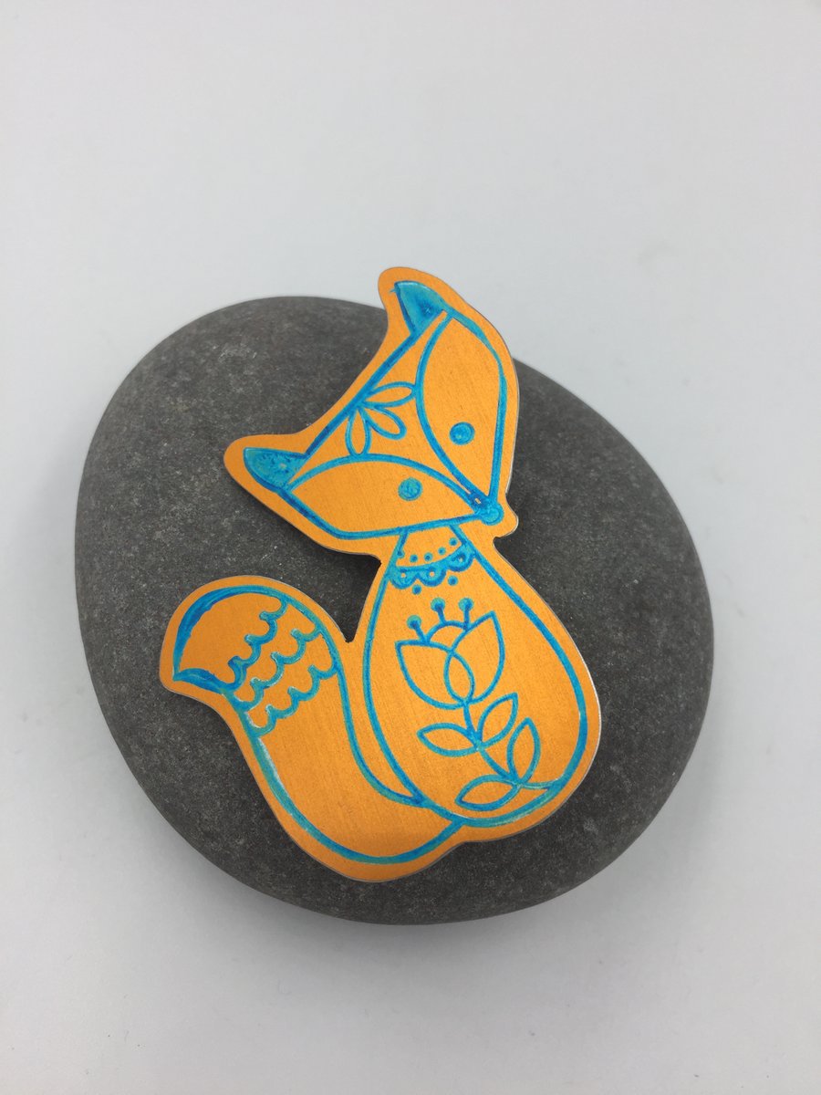 Anodised aluminium fox brooch in turquoise and orange
