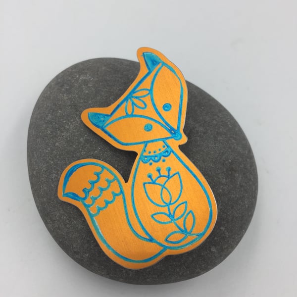 Anodised aluminium fox brooch in turquoise and orange