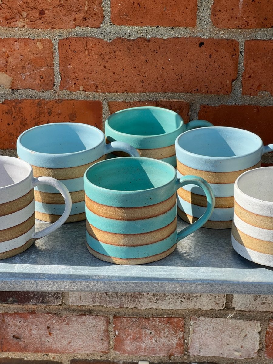 Hand made green or blue pottery mug. 