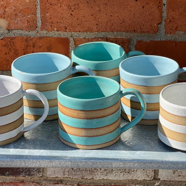 Hand made green or blue pottery mug. 