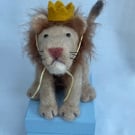 Handcrafted needle felted lion with removable party hat on a wooden box