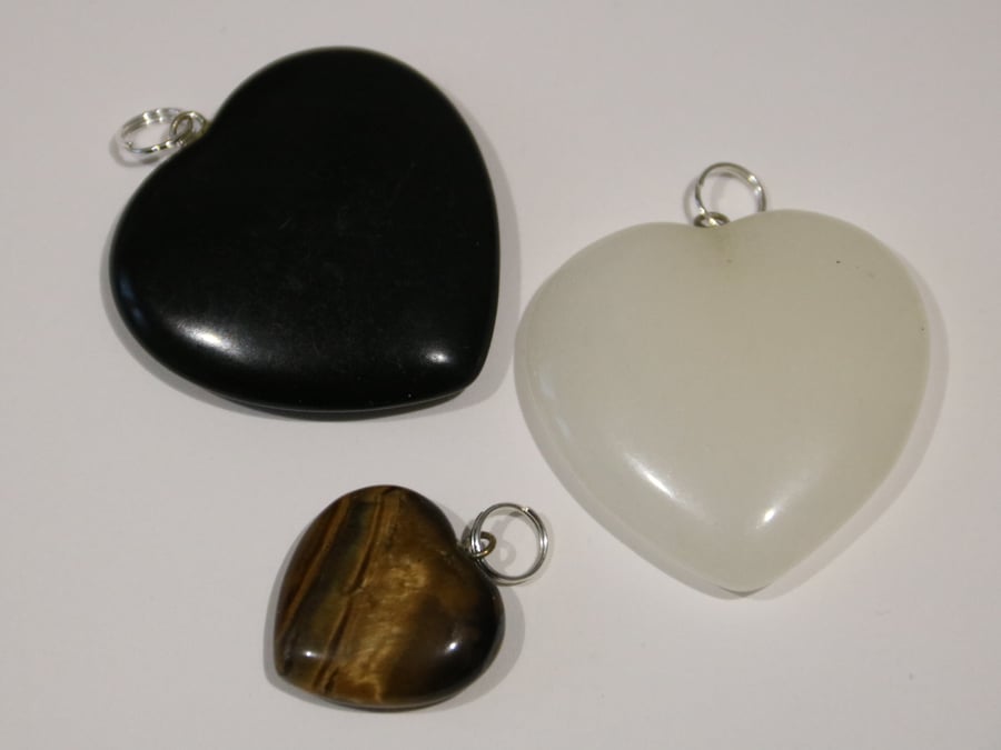 3 gemstone heart pendants: White Quartz, Tiger's Eye and Black Onyx