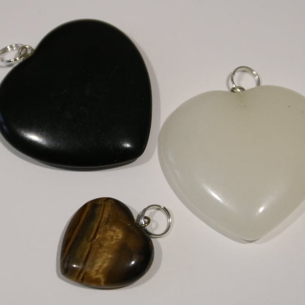 3 gemstone heart pendants: White Quartz, Tiger's Eye and Black Onyx