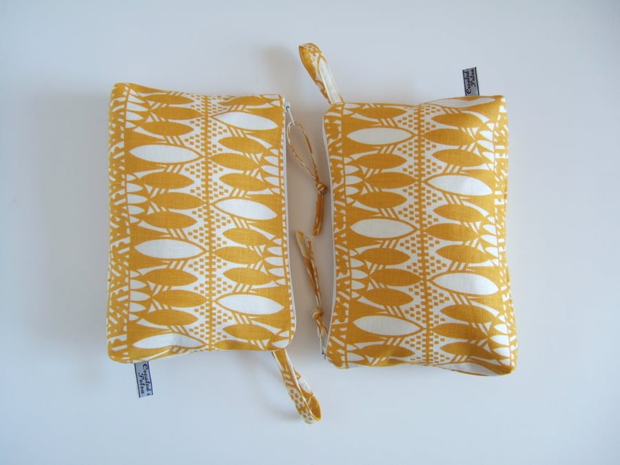 Toiletries or make up bag in bold hand printed yellow fabric.