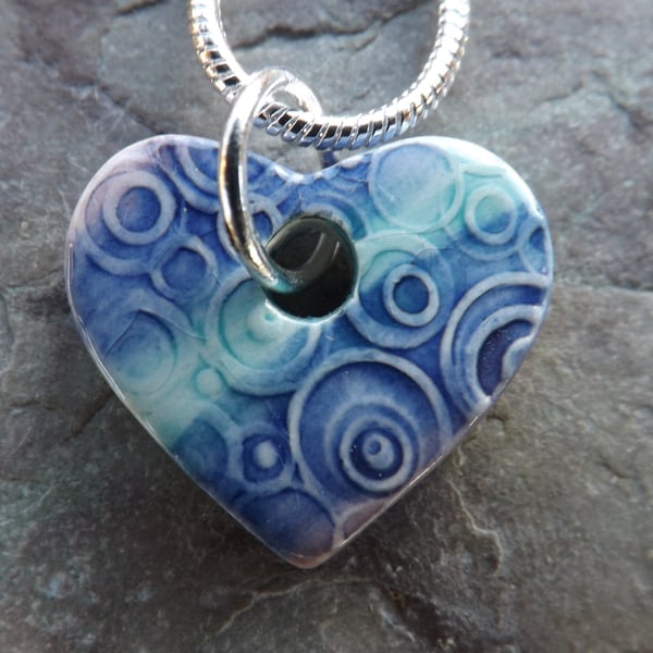 Heart shaped ceramic pendant in purple, turquoise and blue