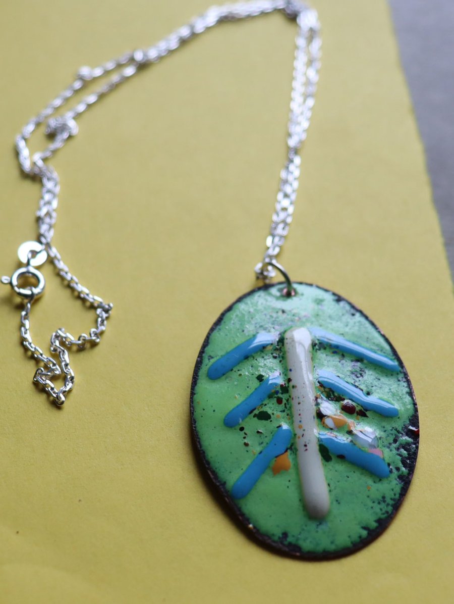Green Oval Kiln-fired enamel pendant decorated with glass threads