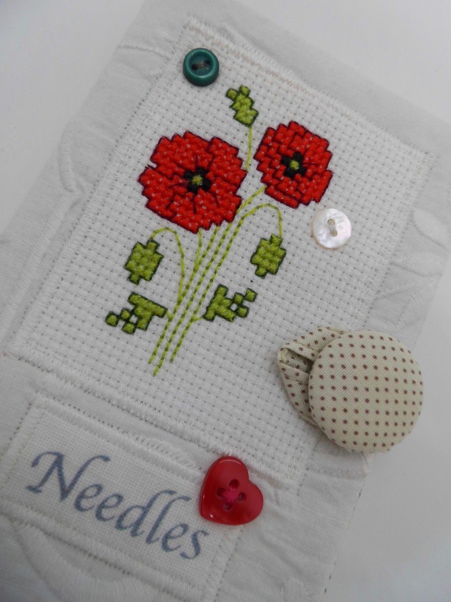 Sewing needle case white with poppy cross stitch.
