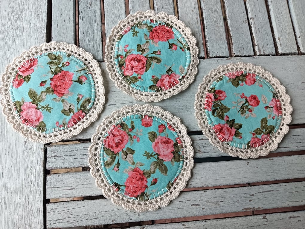 Set of four handmade floral coasters with crochet edge.