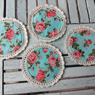 Set of four handmade floral coasters with crochet edge.