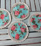 Set of four handmade floral coasters with crochet edge.