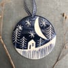 Ceramic Winter scene hanging decoration.