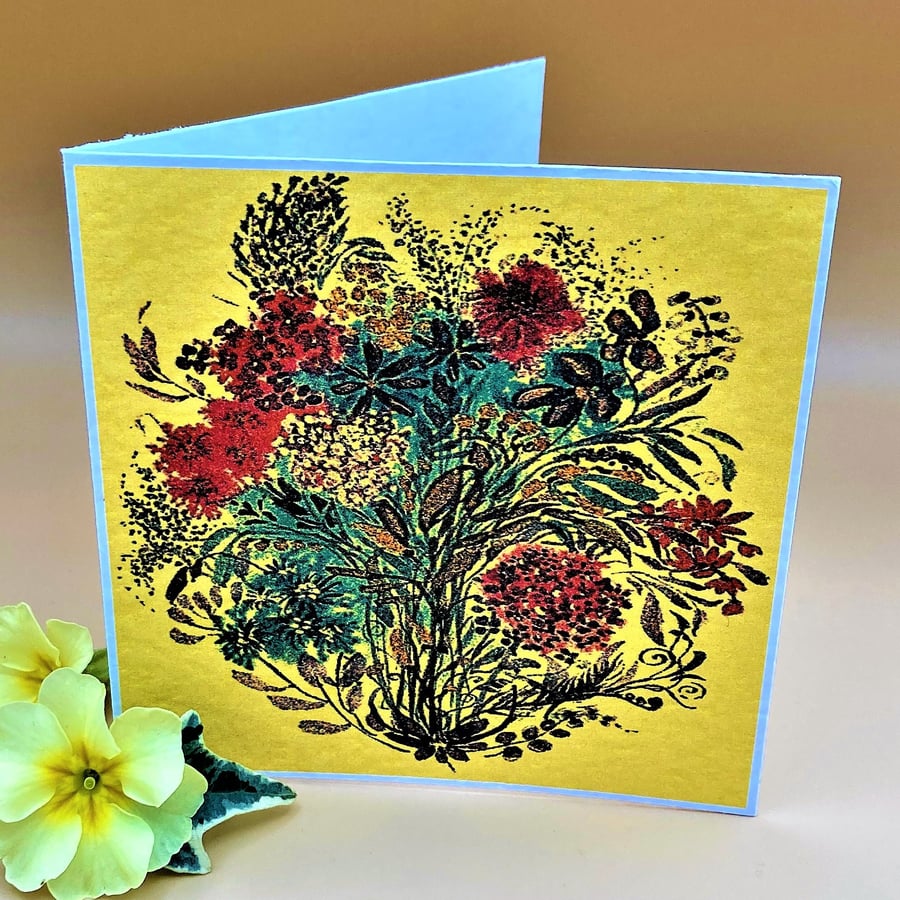 Blank Greetings Card, blue and red flowers on a yellow background, no message. 