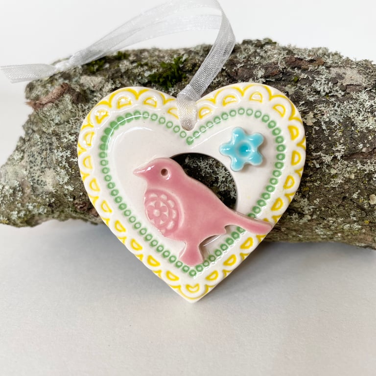 Small Ceramic bird in a yellow heart decoration 