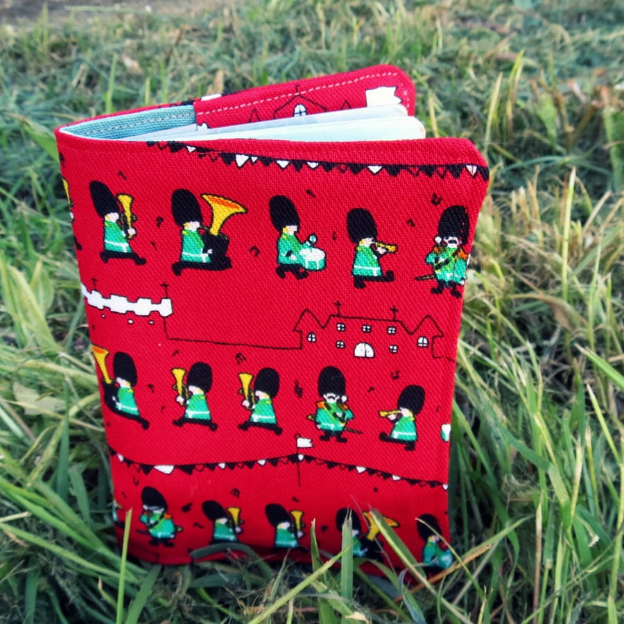A passport cover with a marching soldiers design.  Passport sleeve.