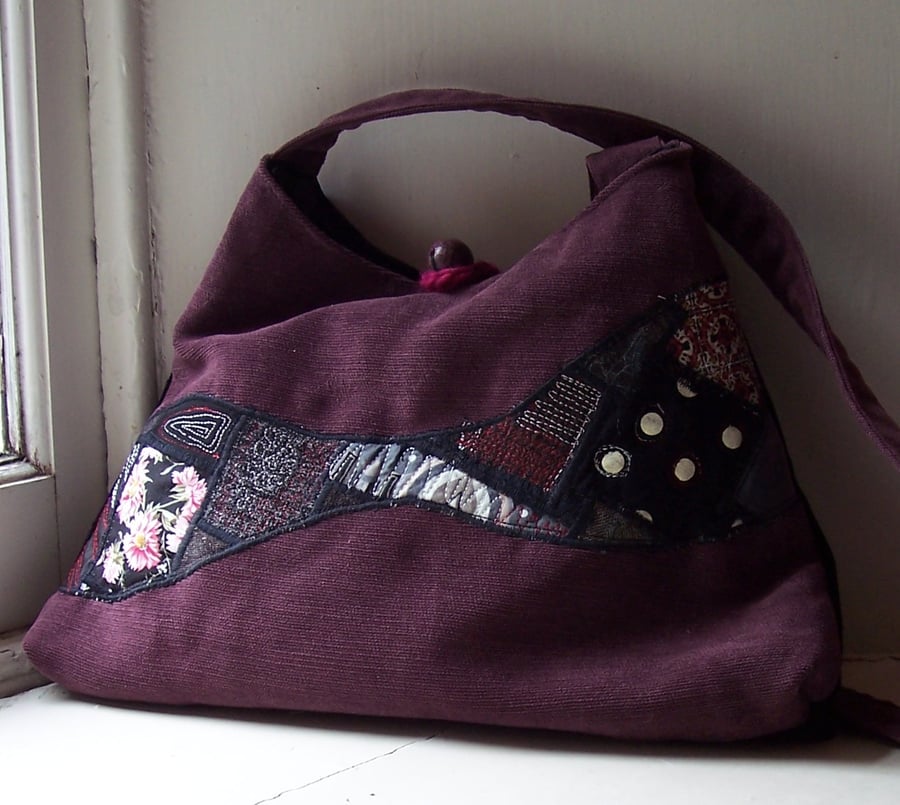 Soft textile handbag in pink, black and purple