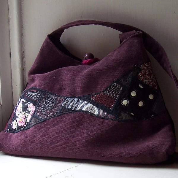 Soft textile handbag in pink, black and purple