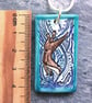 Handmade Ceramic Otter pendant in turquoise blue - Image 3