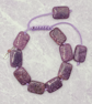 Knotted purple macrame cord bracelet with rectangular lepidolite stones