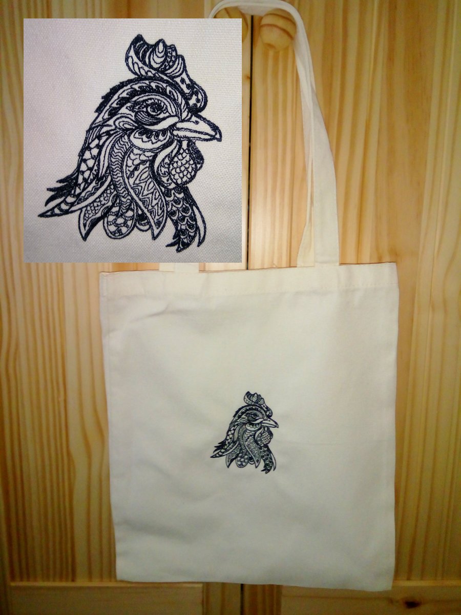 Head of a chicken embroidered on a cream tote bag
