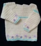 Crochet Baby jumper in cream with mauve embroidered flowers 22 in chest.  - Image 2