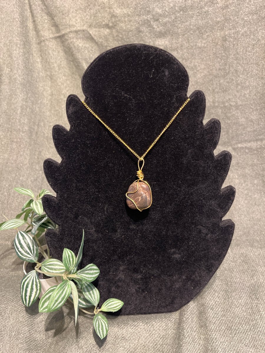 Image of Beautiful wire wrapped brown pebble pendant on gold coloured chain. 