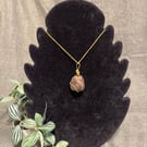 Beautiful wire wrapped brown pebble pendant on gold coloured chain. 