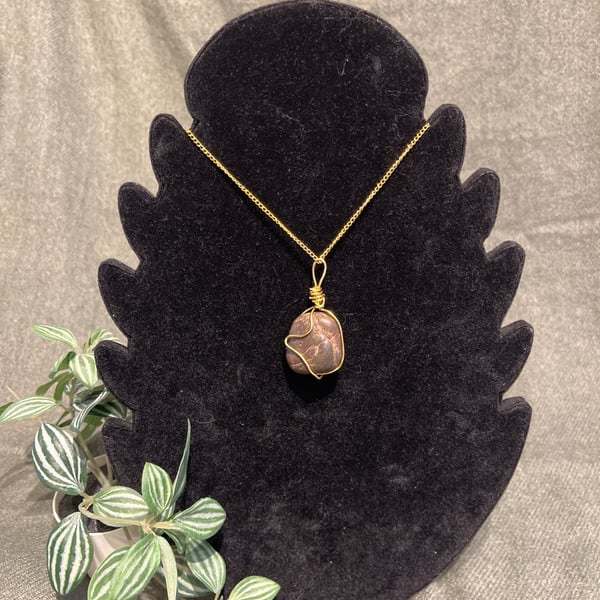 Beautiful wire wrapped brown pebble pendant on gold coloured chain. 