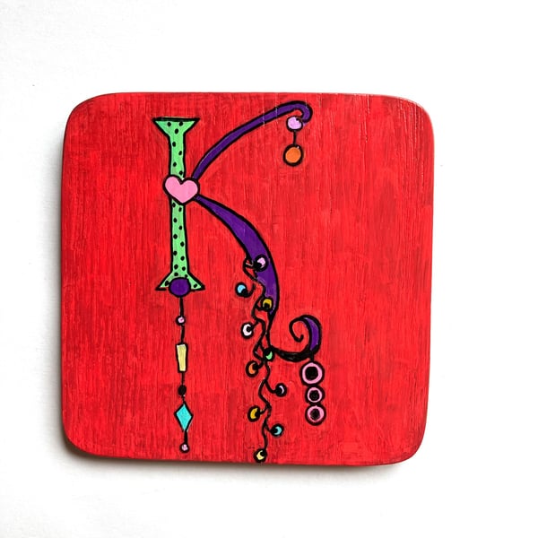 Hand painted letter K wooden coaster