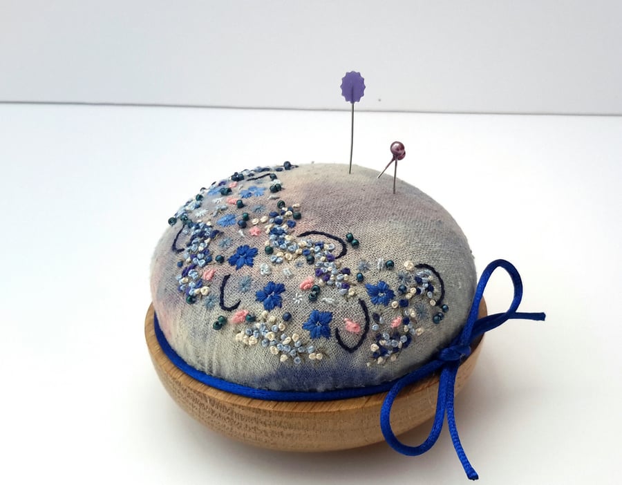 Hand embroidered pin cushion onto hand dyed silk noil and oak base